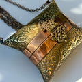 Antique-Style Embossed Brass Pillow Clutch